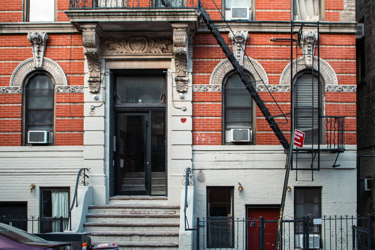 Red-brick walk-up with a fire escape